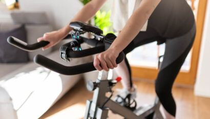 Woman cycling on an exercise bike.