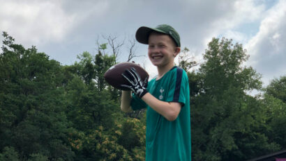 Boy holding a football.