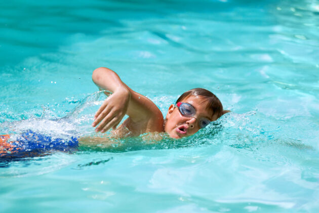 Boy swimming the breast stroke.