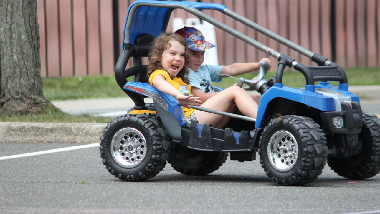 Campers in a little kid car.