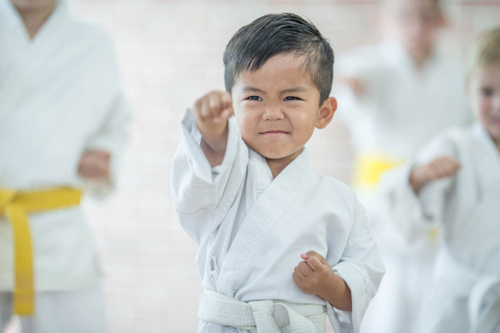 Young boy in a martial arts robe.