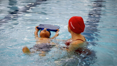 Child and swim instructor during a swim lesson.