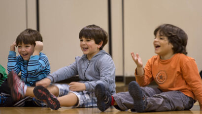 Boys laughing in soccer class.