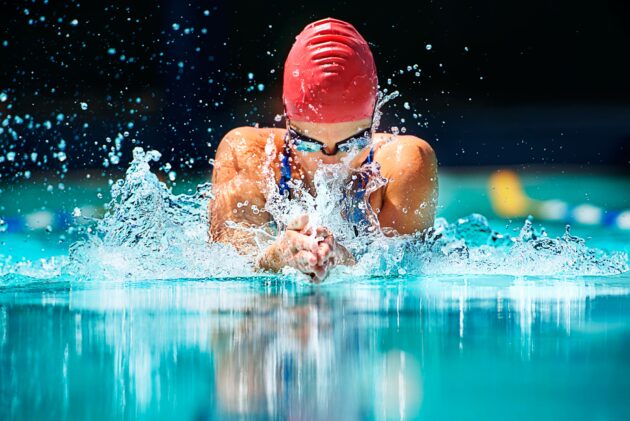 Shot of a young female swimmer doing the butterfly stroke