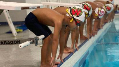 Young swimmers ready to dive into the pool.