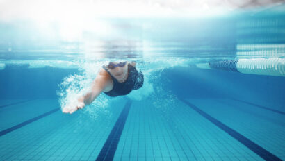 Woman swimming underwater.