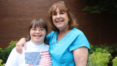 Woman with her arm around a girl.