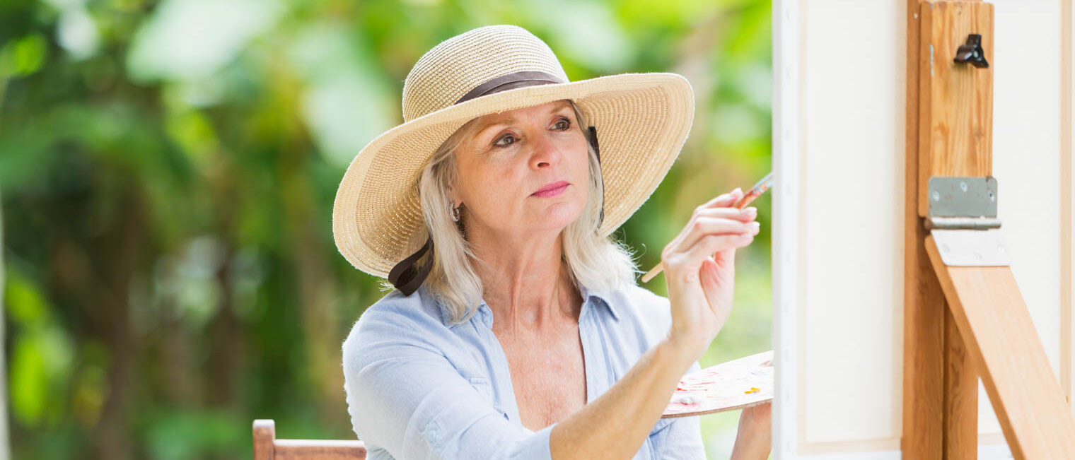 Woman painting outside.