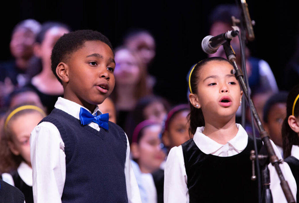 Two children doing a duet on stage.