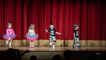 Toddlers doing a hip hop performance on stage.